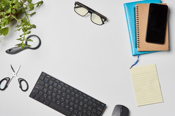 Bright office workspace. Work space with notepad, keyboard, coffee and glasses. Work space table desk. Flat lay, top view, copy space