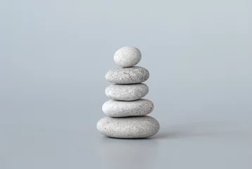 Poster Pebbles stack on grey background, zen balance meditation minimal concept © Enso