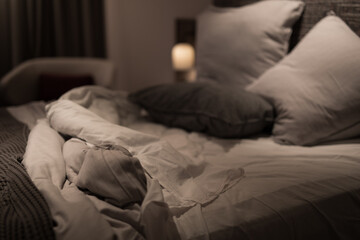Messy bed sheets quilt cover grey white cushions pillows night sleep restless comfortable relax hotel home