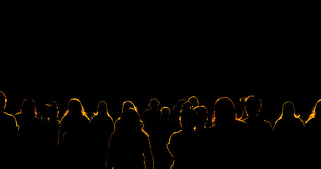 Light shining on crowd of people with yellow outlined silhouettes of bodies on a black background - 491122845