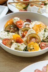 Salad with tomatoes, pine nuts and cheese. Vertical photography