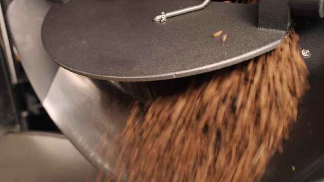Lever is pushed up to let coffee beans fly out of roastery