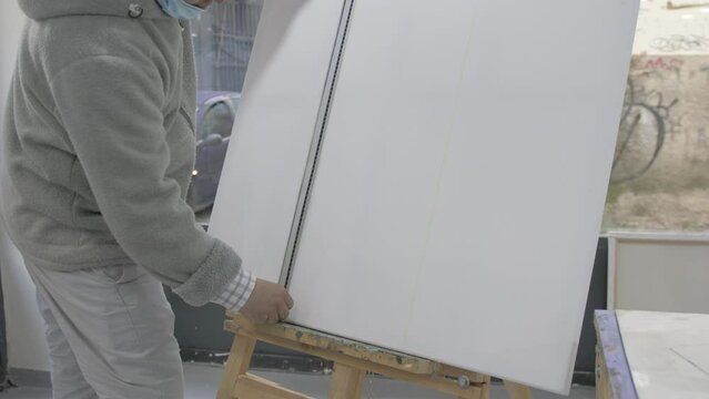 Talented artist ruling line on blank white canvas