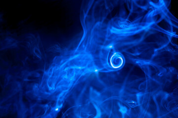 Blue smoke on black background.