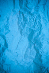 Blue crumpled paper background.