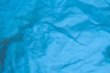 Blue crumpled paper background.