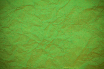 Green crumpled paper background.