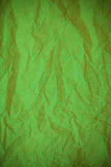 Green crumpled paper background.