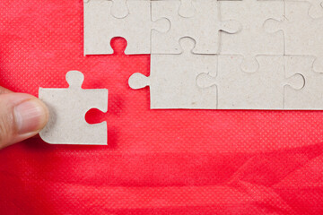 Jigsaw on red background.