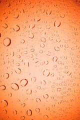 Bubble water on red glass background.