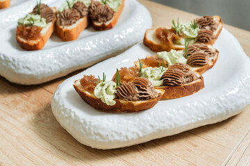 Homemade pate, spread or mousse with sliced bread and herbs.