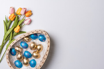 Happy easter time. Bright Easter holiday concept with spring flowers and easter eggs. Colorful Easter eggs background