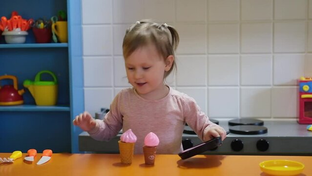 Happy Preschool Girl Playing With Toy Kitchen At Kids Game Center. Fun In Kids Room.