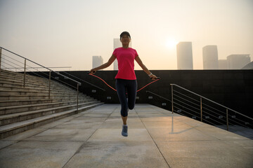 Fitness asian woman jumping rope