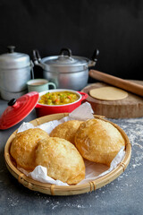 Delicious and healthy homemade Indian meal. Puri aka Poori with Aloo Masala. An Indian vegetarian breakfast or snack meal eaten with spicy potato masala.