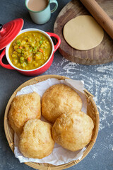 Delicious and healthy homemade Indian meal. Puri aka Poori with Aloo Masala. An Indian vegetarian breakfast or snack meal eaten with spicy potato masala.