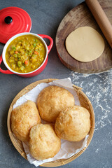 Delicious and healthy homemade Indian meal. Puri aka Poori with Aloo Masala. An Indian vegetarian breakfast or snack meal eaten with spicy potato masala.