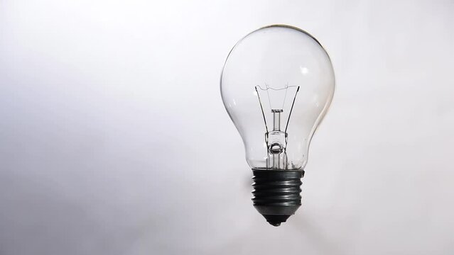 tungsten light bulb lit on white background