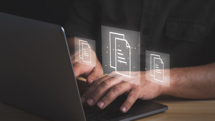 Document management concept.Businessman working with laptop computer with icons on virtual screen.