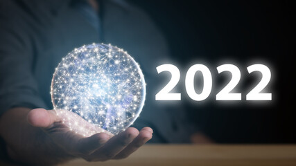 2022.Man holding planet by hand with numbers 2022.Happy New Year 2022 concept.Element of this image from NASA.
