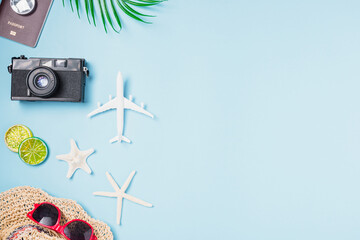 Fototapeta na wymiar Flat lay top view mockup retro camera films, airplane, starfish, shells, hat traveler tropical accessories on a blue background with copy space, Business trip, and vacation summer travel concept