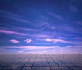 pink clouds, blue sky, gray floor.