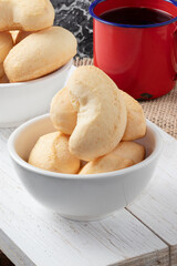 Brazilian cheese biscuit on white bowl and coffee.