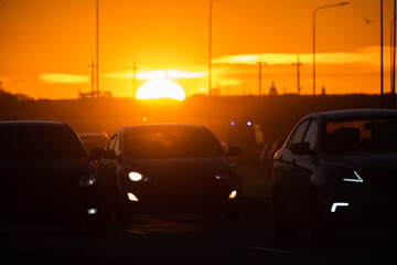 Fototapeta na wymiar Road with cars at sunset