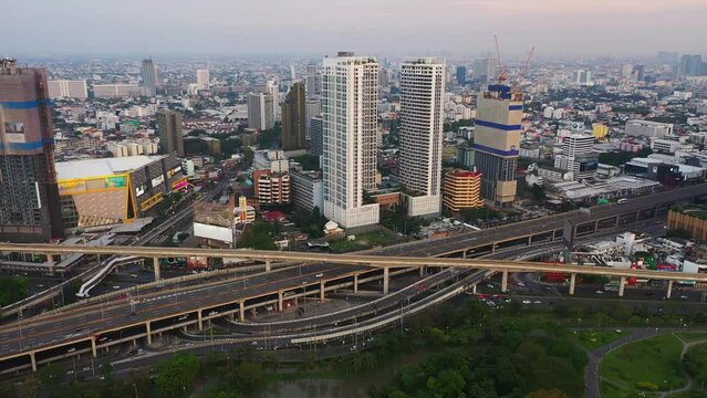 Aerial view of Lat Phrao Road in structure of suspension architecture concept, Urban city, Bangkok. Downtown area at sunset, Thailand.