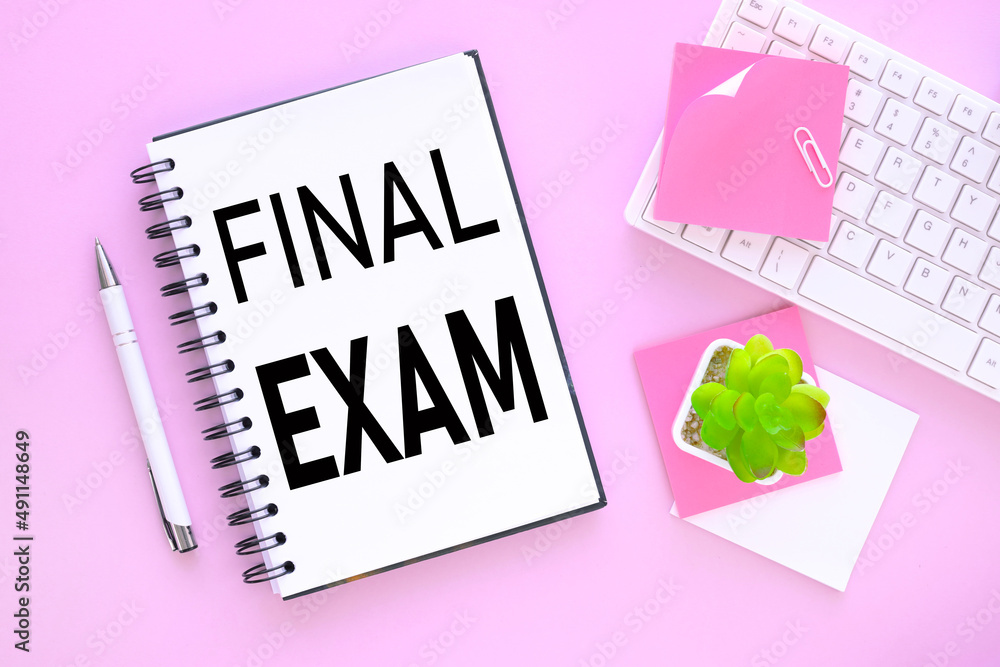 Poster open notepad white keyboard on pink background. text on an open notebook. final exam