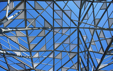Decorative roof in the shape of a triangle in a park square with a clear blue sky