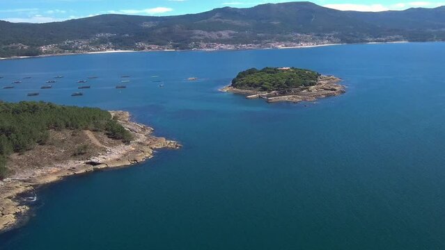 Aerial View Of Illa De Creba With Mussel Seafood farms in Ria Muros y Noya Galicia Spain. Dolly Back
