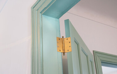 Hinges hardware of the opening and closing doors of room entrances