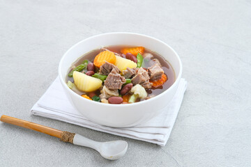 Sup daging kacang merah, clear soup with beef slices, red bean and vegetables. Served in bowl on...