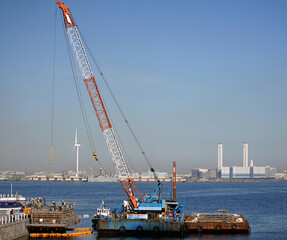 Fototapeta premium Offshore cranes at work sites in Japanese ports