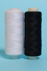Coils with black and white threads on a blue background