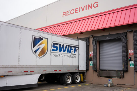 Aloha, OR, USA - Jan 21, 2022: American Trucking Company Swift Transportation Branded Truck Is Seen At The Loading Dock In A Costco Wholesale Store In Aloha, Oregon.