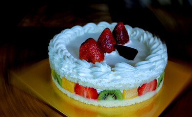 Organic fruit cake with strawberries, pineapple, kiwi