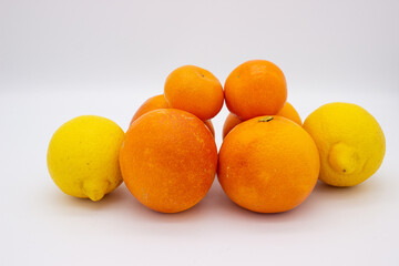 Few oranges, tangerines and lemons on white background.