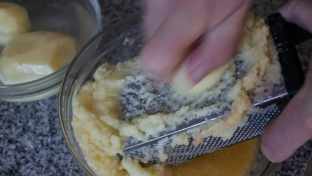 Closeup of Cooking otato pancakes draniki on grater . High quality FullHD footage