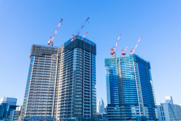 Fototapeta na wymiar Tower condominium under construction and large crane_05