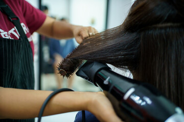 Fototapeta premium Asian young woman have a hair cutting and spa by professional beauty hair dresser. 