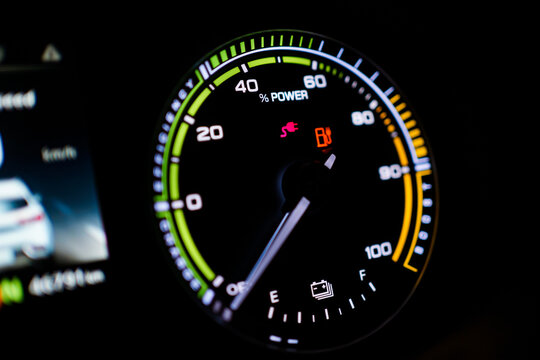 Digital modern dashboard in a electric vehicle - EV while charging at the charging station.