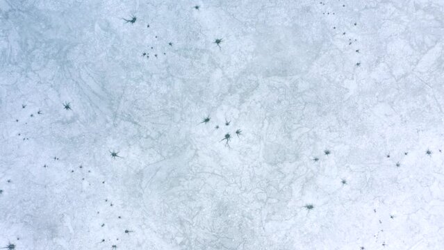 Top down view of empty frozen pond. Filmed in 4k, drone video.