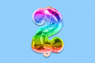 Rainbow foil balloon number, digit two on a blue background. Birthday greeting card with inscription 2. Top view. Numerical digit. Celebration event, template.