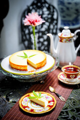 Cheesecake dessert pie, dairy recipe homemade on table. Delicious fresh peace of cake slice on plate. Tasty sweet food cannabis leaves on top. Morning gourmet plate closeup dish photography.
