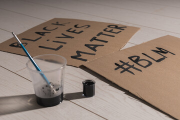 Black lives matter and fight against racism and write sign and words on cardboard - protest concept...