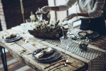 Table setting. The woman decorates the table. High quality photo