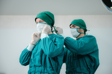 Fototapeta na wymiar surgical doctor person are wearing protected suit medical operation uniform, medicine specialist in green doctor clinic suit at hospital