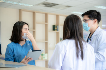 professional doctor and medicine person team have a conversation to talking in hospital about medical health care work, wearing surgical face mask